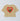 Beige cropped t-shirt with red heart and green palm tree graphic and "ciao" text on back.