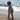 White oversized t-shirt with yellow "amore" text worn by toddler on sandy beach near ocean waves.