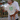 Cream-colored toddler t-shirt with green "in my playdate era" graphic, worn by child with red sunglasses.
